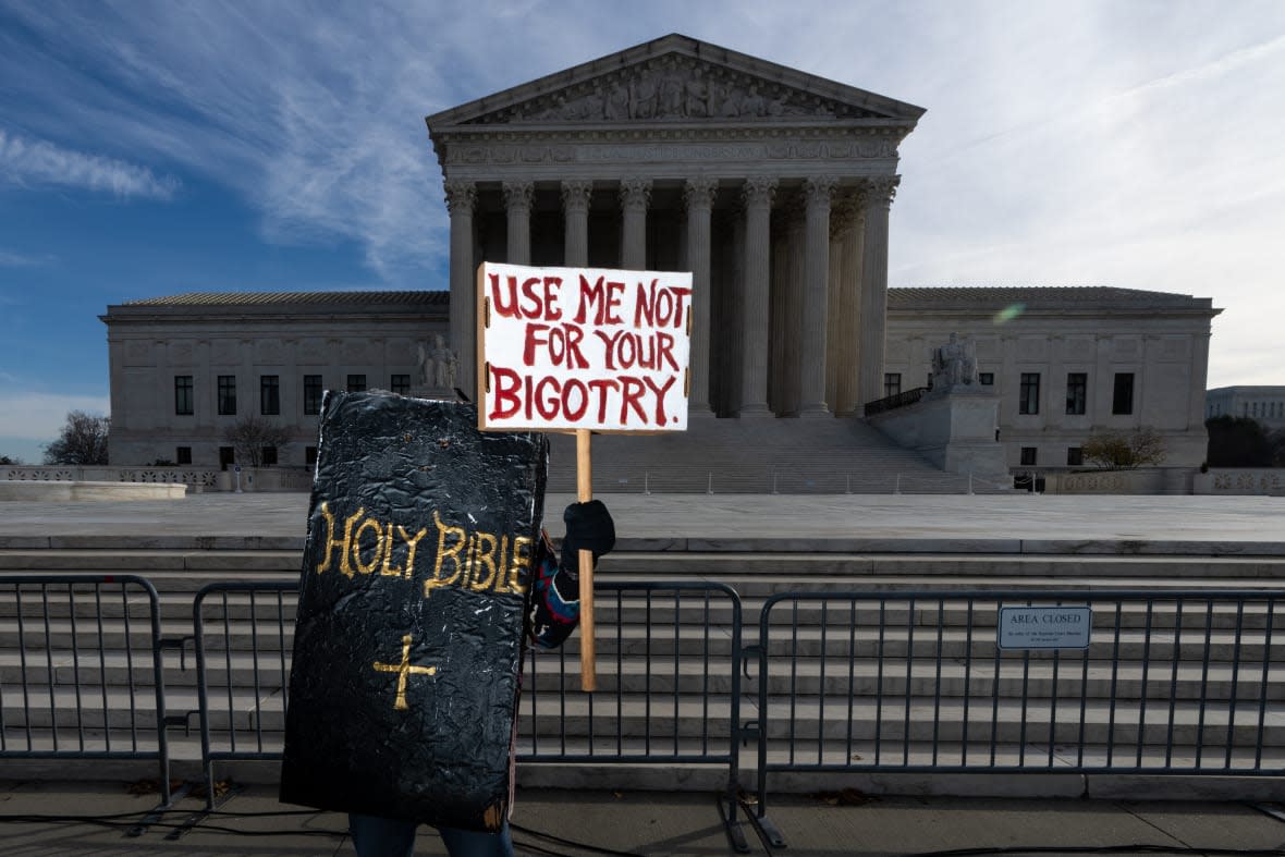 A protester dressed in a Bible costume on Nov. 5, 2022, stands in front of the U.S. Supreme Court during the 303 Creative LLC v. Elenis case hearing before the court. (Bill Clark/CQ-Roll Call, Inc via Getty Images)