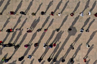 This photo released by Xinhua News Agency shows an aerial view of residents lining up to receive a swab for the coronavirus test during a mass testing in Xingqing District of Yinchuan in northwest China's Ningxia Hui Autonomous Region Saturday, Oct. 23, 2021. China's Gansu has closed all tourist sites following the reporting of new COVID-19 cases in the northwestern province. Gansu lies along the ancient Silk Road and is famed for the Dunhuang grottoes filled with Buddhist images and other ancient religious sites. (Wang Peng/Xinhua via AP)