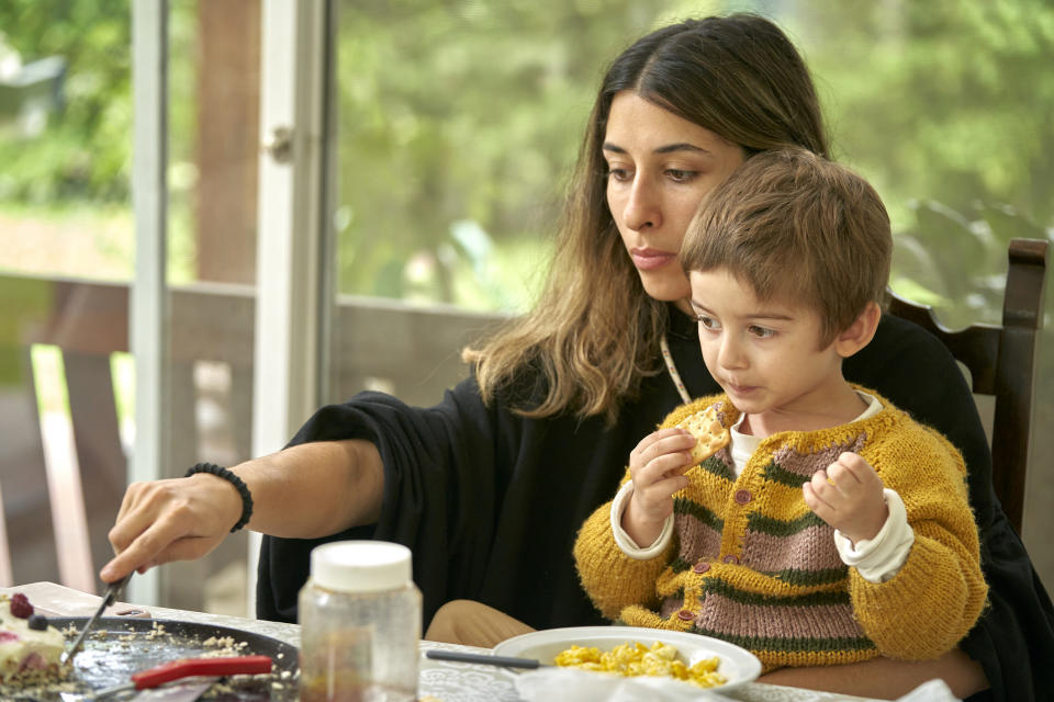 mom eating with son on her lap