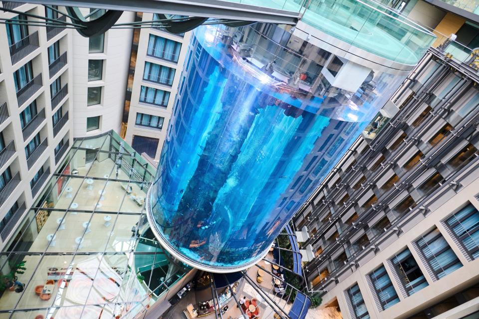 The AquaDom aquarium at the Sea Life tourist attraction photographed in Berlin, Wednesday, June 1, 2022. The aquarium is bursts on Friday, Dec. 16, 2022. Operators say the aquarium has the biggest cylindrical tank in the world. It contained 1,500 tropical fish before the incident. (Annette Riedl/dpa via AP)