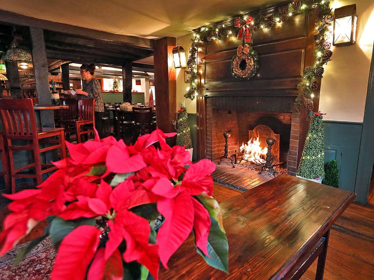 The 1741 Sun Tavern in Duxbury features an original fireplace near the dining room and bar. The fireplace screen was removed for photography on Thursday, Dec. 16, 2021.