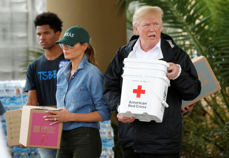 <p>President Donald Trump and first lady Melania Trump help volunteers deliver supplies to residents at a relief supply drive-thru during a visit with flood survivors and volunteers in the aftermath of Hurricane Harvey in Houston, Texas, Sept. 2, 2017. (Photo: Kevin Lamarque/Reuters) </p>