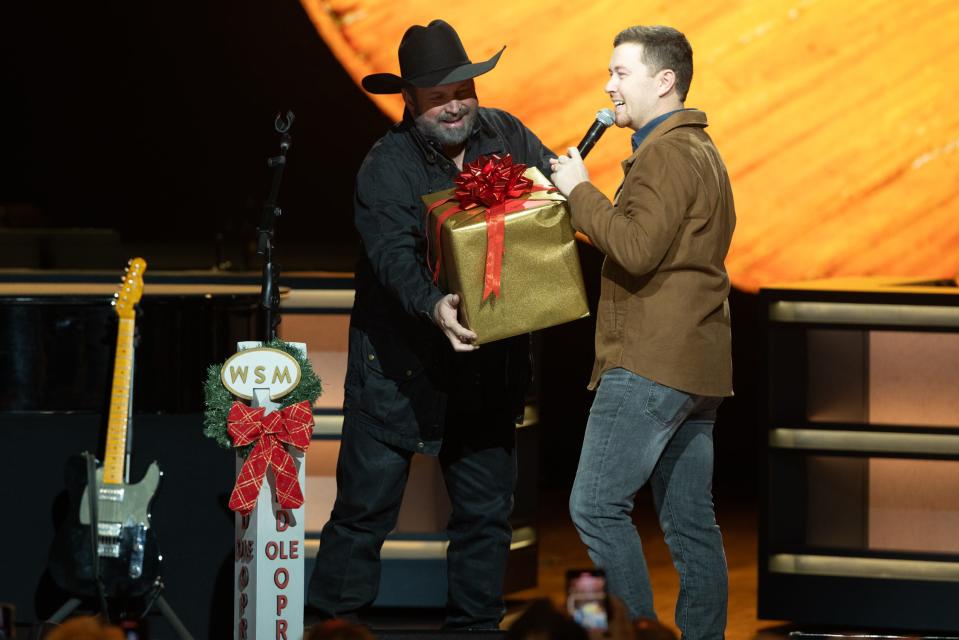 Scotty McCreery invited to become a member of the Grand Ole Opry by Garth Brooks.