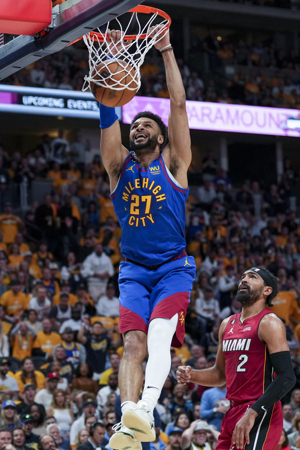 Denver Nuggets guard Jamal Murray dunks next to Miami Heat guard Gabe Vincent during the first half of Game 1 of basketball's NBA Finals, Thursday, June 1, 2023, in Denver. (AP Photo/Jack Dempsey)