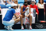 French Captain Julien Benneteau consoles Caroline Garcia as she suffered a defeat by Australia's Ashleigh Barty during their Fed Cup tennis final in Perth, Australia, Saturday, Nov. 9, 2019. (AP Photo/Trevor Collens)