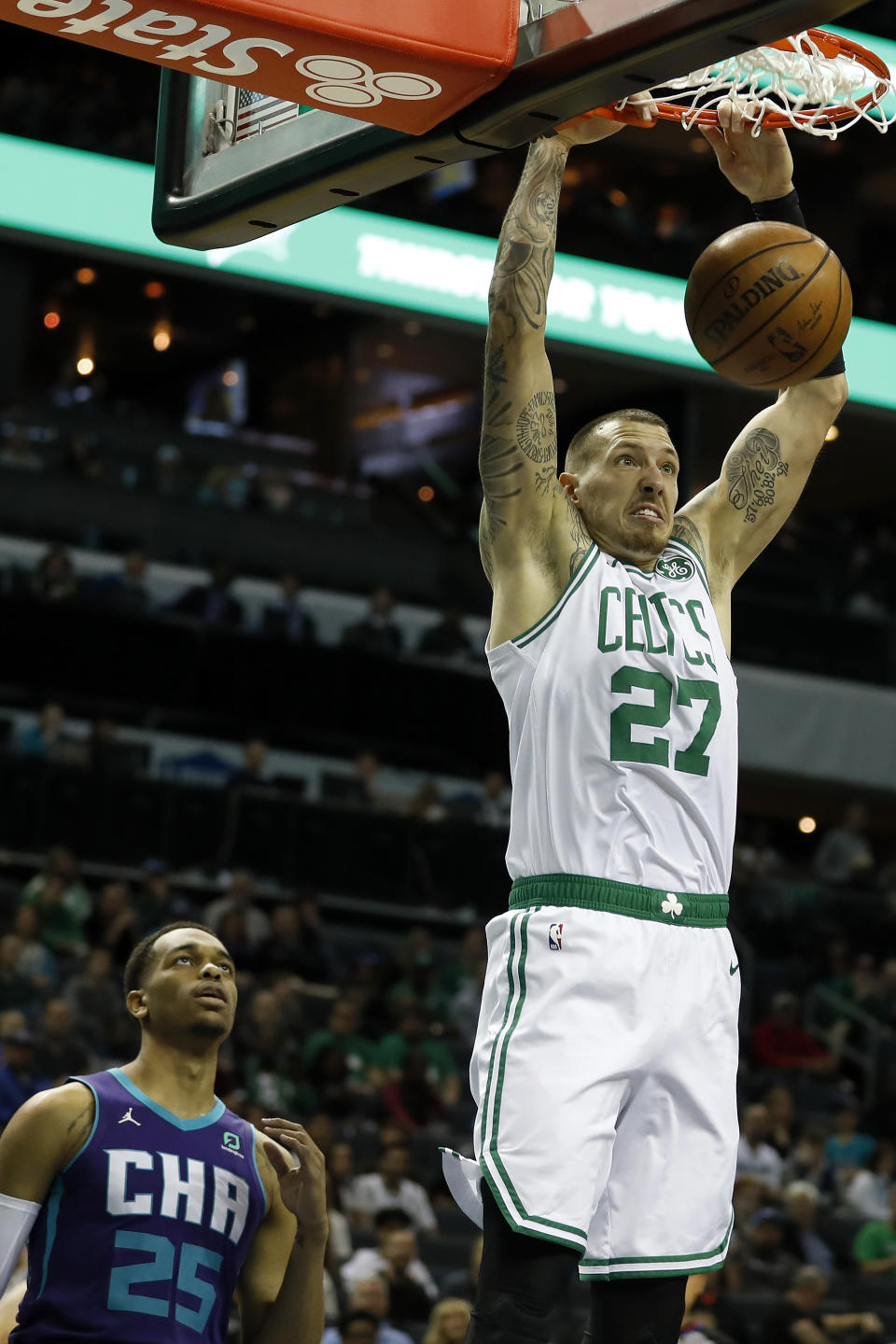 Boston Celtics' Daniel Theis (27) dunks as Charlotte Hornets' P.J. Washington (25) can only watch during the first half of an NBA basketball game in Charlotte, N.C., Tuesday, Dec. 31, 2019. (AP Photo/Bob Leverone)