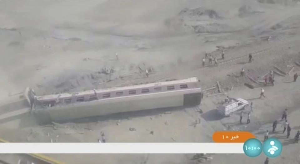 This image taken from video from Iranian state television shows a train car on its side after a derailment outside of Tabas, Iran, Wednesday, June 8, 2022. A passenger train partially derailed in eastern Iran early Wednesday, killing at least 17 people and injuring 50 more, including some critically, authorities said. (IRIB via AP)