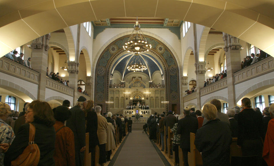 In this Friday, Aug. 31, 2007 file photo rabbis carry the Torah scrolls in a solemn procession during the reopening after renovation of Germany's biggest synagogue at the Rykestrasse in Berlin's district Prenzlauer Berg. The epicenter of the Holocaust, the city where Hitler signed the death warrants of 6 million Jews, seems an unlikely candidate for the world’s fastest growing Jewish community. But despite this stigma of Nazism, Berlin’s dynamic, prosperous present and its rich, pre-World War II Jewish past initially attracted an influx from the former Soviet Union and has continued with the arrival of thousands of Israelis and smaller numbers of often young immigrants from Australia, France, the United States and elsewhere. (AP Photo/Markus Schreiber,File)