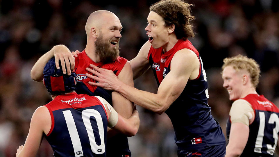 Melbourne Demons players are pictured here reacting to a goal in their preliminary final win.