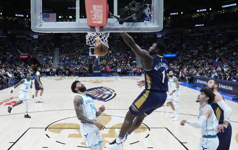 New Orleans Pelicans forward Zion Williamson (1) slam dunks over Charlotte Hornets center Nick Richards (4) in the first half of an NBA basketball game in New Orleans, Wednesday, Jan. 17, 2024. (AP Photo/Gerald Herbert)