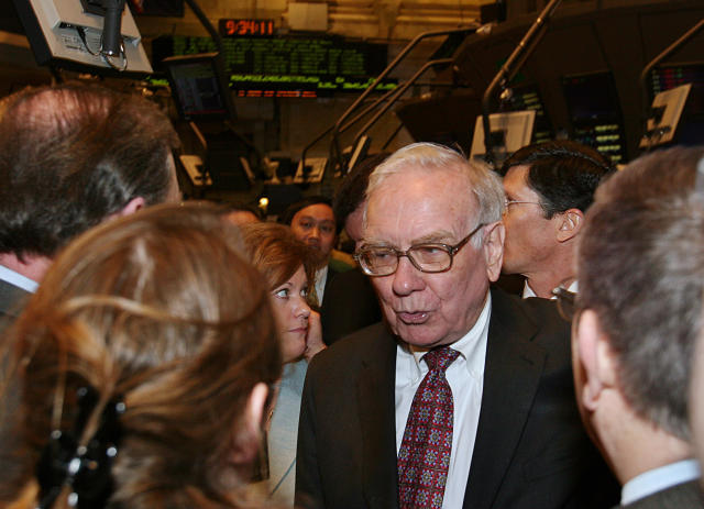 Warren Buffett, Chairman of Berkshire Hathaway, talks to reporters on the floor of the New York Stock Exchange in New York, March 20, 2006. REUTERS/Seth Wenig