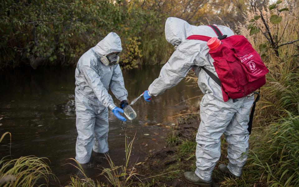 Experts collect water samples during the Greenpeace expedition to inspect territories of Kamchatka peninsula  - REUTERS