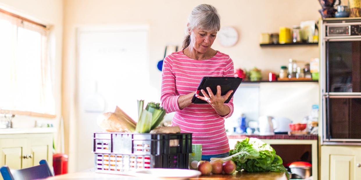 senior ordering grocery delivery tablet kitchen