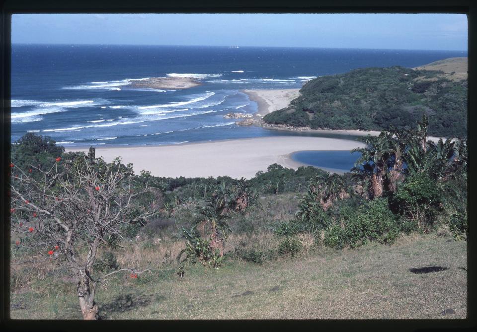 The Mzikaba estuary, showing Mzikaba island, beyond which is the reef where the cannons were found. KwaZulu-Natal Museum photographic archive. Photographer unrecorded (1986). KwaZulu-Natal Museum