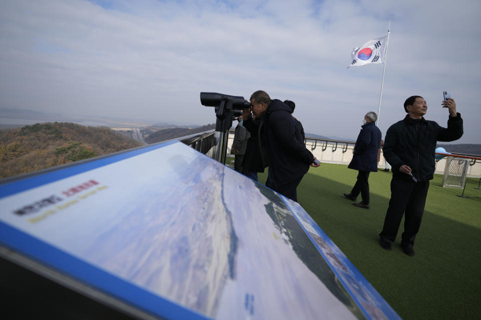 Visitors use binoculars to see the North Korean side from the unification observatory, in Paju, South Korea, Wednesday, Nov. 22, 2023. South Korea will partially suspend an inter-Korean agreement Wednesday to restart frontline aerial surveillance of North Korea, after the North said it launched a military spy satellite in violation of United Nations bans, Seoul officials said. (AP Photo/Lee Jin-man)