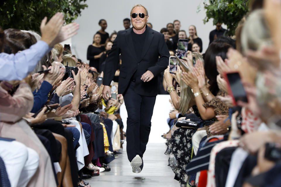 Designer Michael Kors is applauded on the runway after his collection was modeled during Fashion Week in New York, Wednesday, Sept. 11, 2019. (AP Photo/Richard Drew)