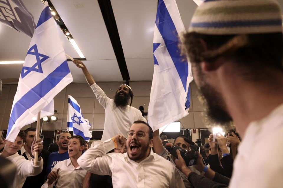 Supporters of Israeli far-right lawmaker and the head of "Jewish Power" party, Itamar Ben-Gvir, celebrates after first exit poll results for the Israeli Parliamentary election at the party's headquarters in Jerusalem, Tuesday, Nov. 1, 2022. (AP Photo/Oren Ziv)