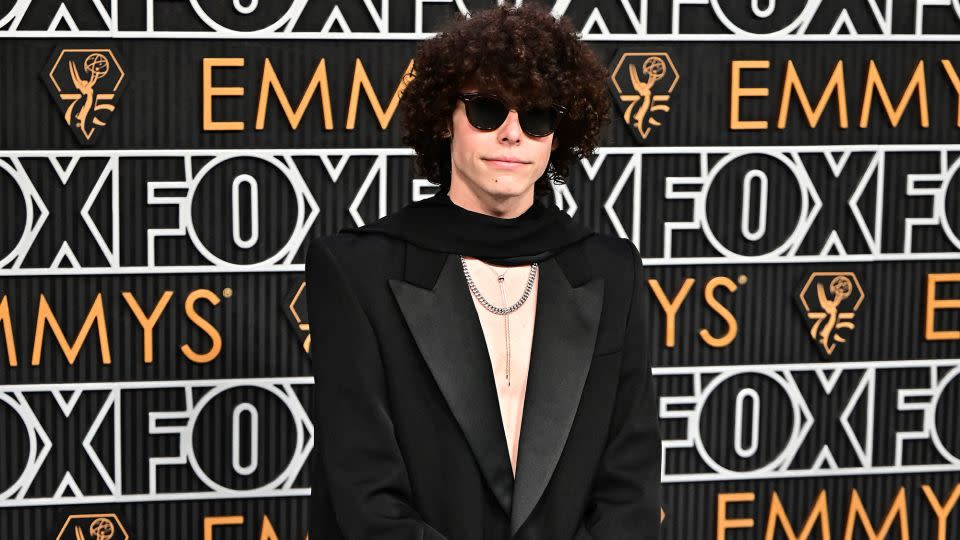 Channeling a little rock glam, actor Reece Feldman opted to go shirtless in a Saint Laurent tuxedo, trailing black scarf and silver jewelry. - Frederic J. Brown/AFP/Getty Images