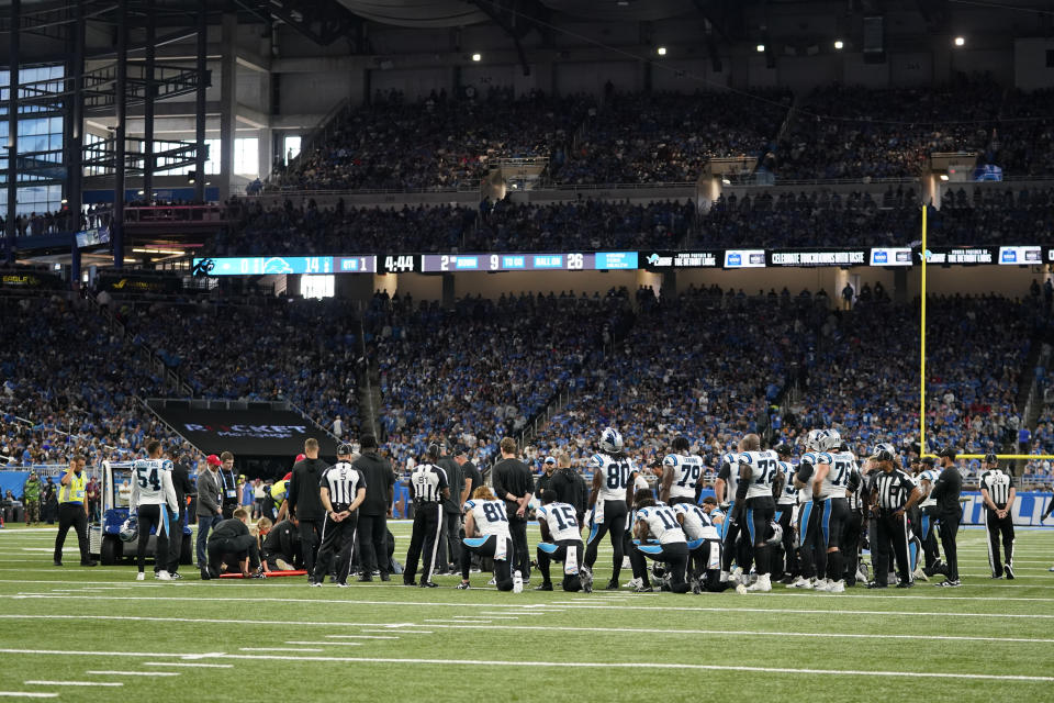 Carolina Panthers players kneel as guard Chandler Zavala is treated after being injured in the first half of an NFL football game against the Detroit Lions in Detroit, Sunday, Oct. 8, 2023. (AP Photo/Paul Sancya)