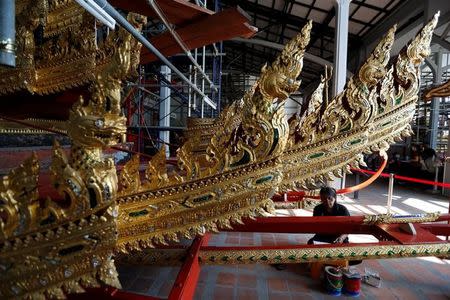 Thai officials from the Conservation Science Division of the Fine Arts Department of the National Museum of Thailand repairs the Royal Chariot, which will be used during the late King Bhumibol Adulyadej's funeral later this year, Thailand, February 6, 2017. REUTERS/Chaiwat Subprasom