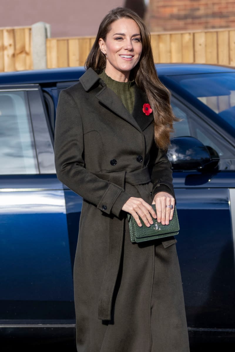<p> Kate is also a big fan of Jimmy Choo, for both her bags and footwear. During her visit to Colham Manor Children's Centre in November 2022, she paired the green, crocodile textured Jimmy Choo Palace clutch with a similar forest green coat with a cinching belt detail for the ultimate cosy winter look. </p>
