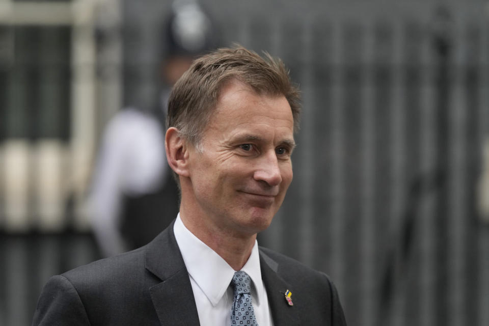 FTSE 100 FILE - Chancellor of the Exchequer Jeremy Hunt leaves 10 Downing Street following a Cabinet meeting, the first held by the new British Prime Minister Rishi Sunak, in London, Wednesday, Oct. 26, 2022. Hunt, Britain’s Treasury chief, warned Sunday Nov. 13, 2022, of a coming spending crunch and tax increases for cash-strapped Britons as he bids to fill the “black hole” in the country’s finances. (AP Photo/Frank Augstein, File)