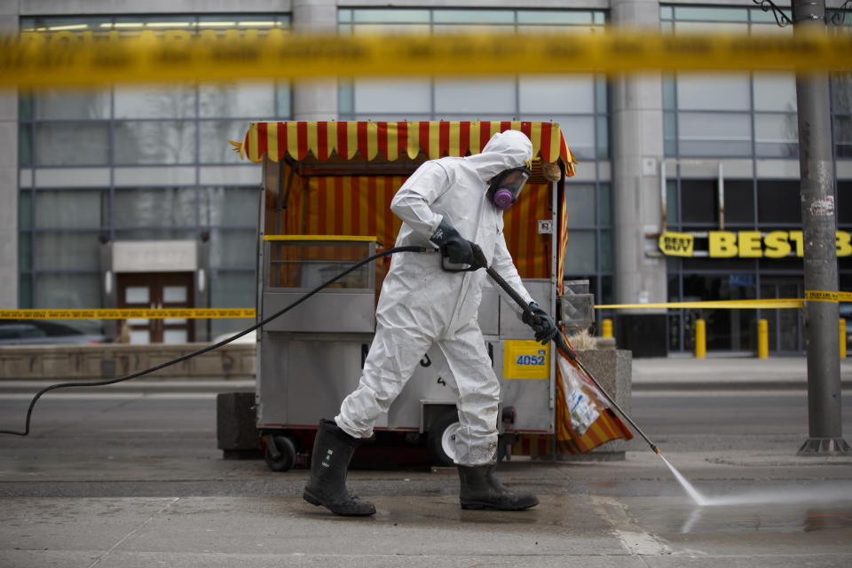 <p>A hazmat worker scrubs the sidewalk of blood and debris after a mass killing on Yonge St. at Finch Ave. on April 24, 2018 in Toronto, Canada. (Photo: Cole Burston/Getty Images) </p>