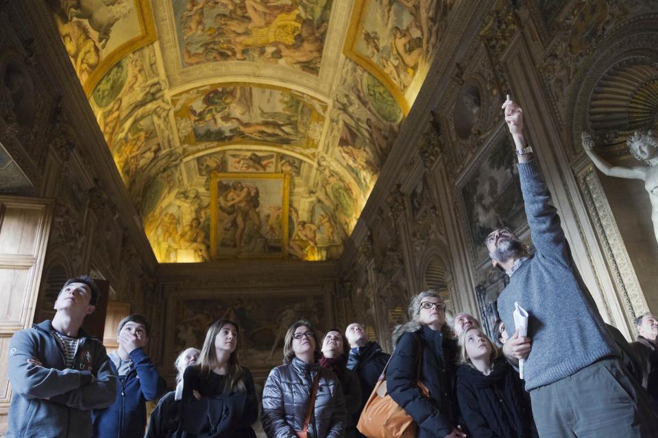 A guide, right, shows the frescoed ceilings of the Carracci Gallery in the Farnese Palace that hosts the French Embassy in Rome, Wednesday, Feb. 26, 2014. The World Monuments Fund Europe will allocate some 800 million Euros for the restoration of the about 140 square meters of 16th century frescoes by Annibale and Agostino Carracci that will begin mid March and are expected to be completed in 2015. (AP Photo/Domenico Stinellis)