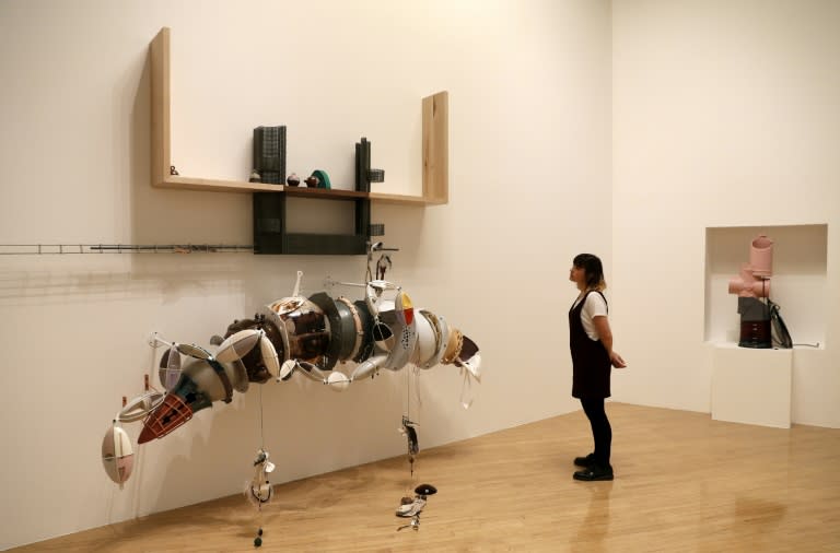 This file photo taken on September 26, 2016 shows a woman looking at pieces of artwork forming an installation by artist Helen Marten, during a photocall for the 2016 Turner Prize