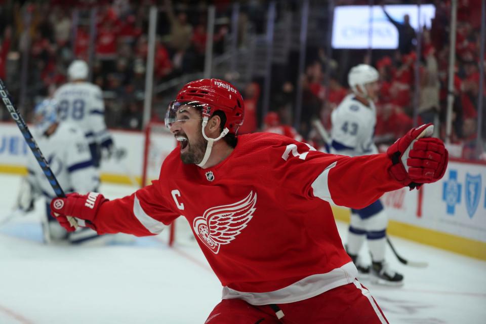 Detroit Red Wings center Dylan Larkin celebrates a goal by right wing Alex DeBrincat against the Tampa Bay Lightning during first-period action Oct. 14, 2023 at Little Caesars Arena in Detroit.