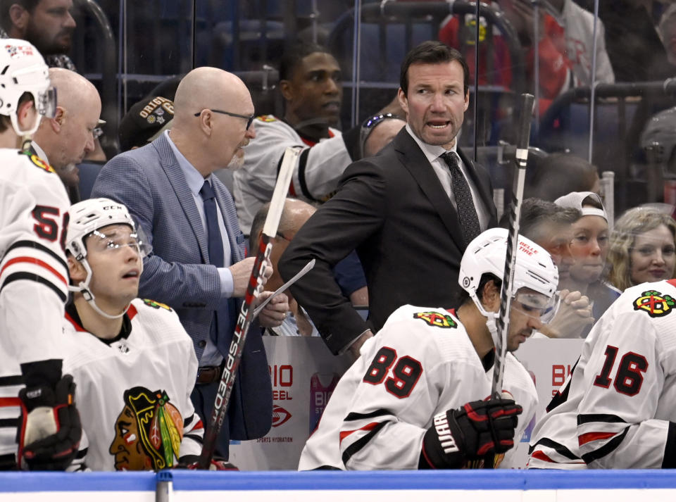 Chicago Blackhawks coach Luke Richardson, top right, looks on during the third period of an NHL hockey game against the Tampa Bay Lightning, Saturday, March 11, 2023, in Tampa, Fla. (AP Photo/Jason Behnken)