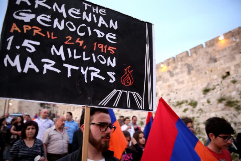 Members of the Armenian community of Jerusalem carry their national flag on April 23, 2016, in Jerusalem's Old City as they march in commemoration of the anniversary of the mass killings of Armenians by Ottoman Turks in 1915