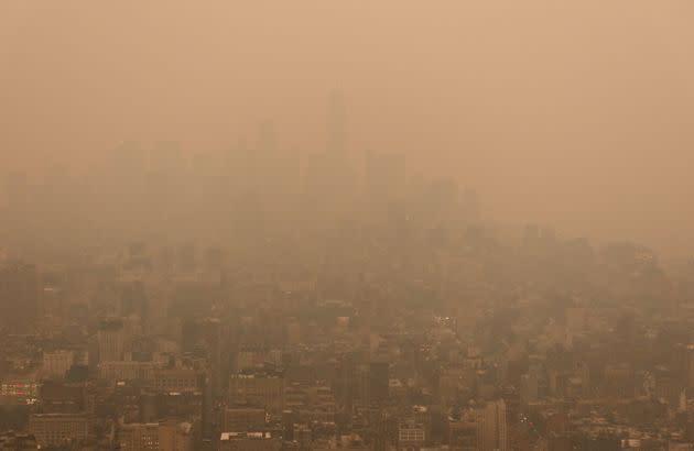 Lower Manhattan is barely visible as heavy smoke cloaks Manhattan in a view looking south from the Empire State Building as the sun sets on Tuesday.