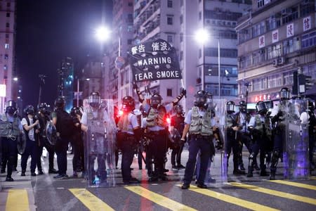 Police stand at a junction in the Sham Shui Po neighbourhood during clashes with anti-extradition bill protesters in Hong Kong