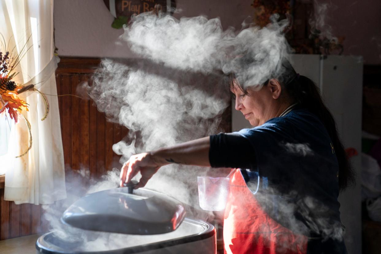Dianne McMahon, 64, of Baraga, stirs beef stew cooking inside an electric roaster before the annual Hunter's Stew inside Herman Hall on Saturday, Nov. 18, 2023.