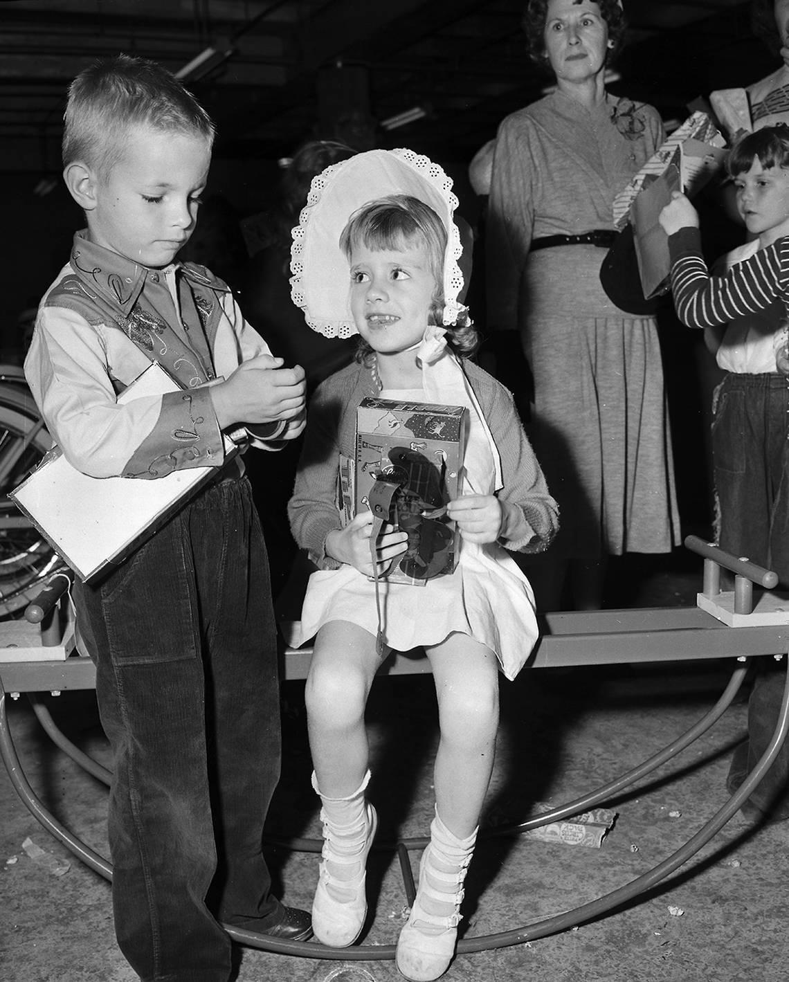 Oct. 19, 1950: B.C. Hathaway, 6, and Linda McClellan, 4, show each other the gifts they received in a surprise package at Leonard’s Department Store’s Toyland. They were among 375 youngsters getting a Christmas preview.