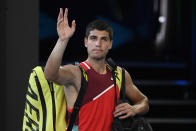 Carlos Alcaraz of Spain waves as he leaves Rod Laver Arena following his third round loss to Matteo Berrettini of Italy at the Australian Open tennis championships in Melbourne, Australia, Friday, Jan. 21, 2022. (AP Photo/Andy Brownbill)