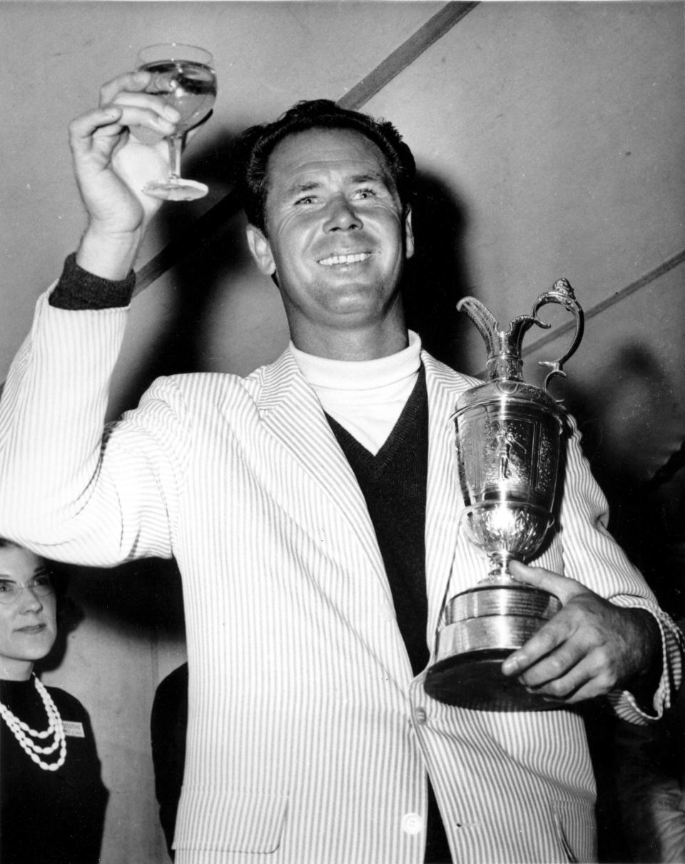 FILE - Tony Lema holds a glass of champagne and his trophy after winning the British Open Golf Championship at St. Andrews, Scotland on July 10, 1964. (AP Photo, File)