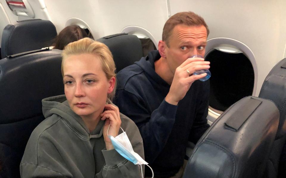 Russian opposition leader Alexei Navalny and his wife Yulia Navalnaya are seen on board a plane during a flight from Berlin to Moscow - Reuters