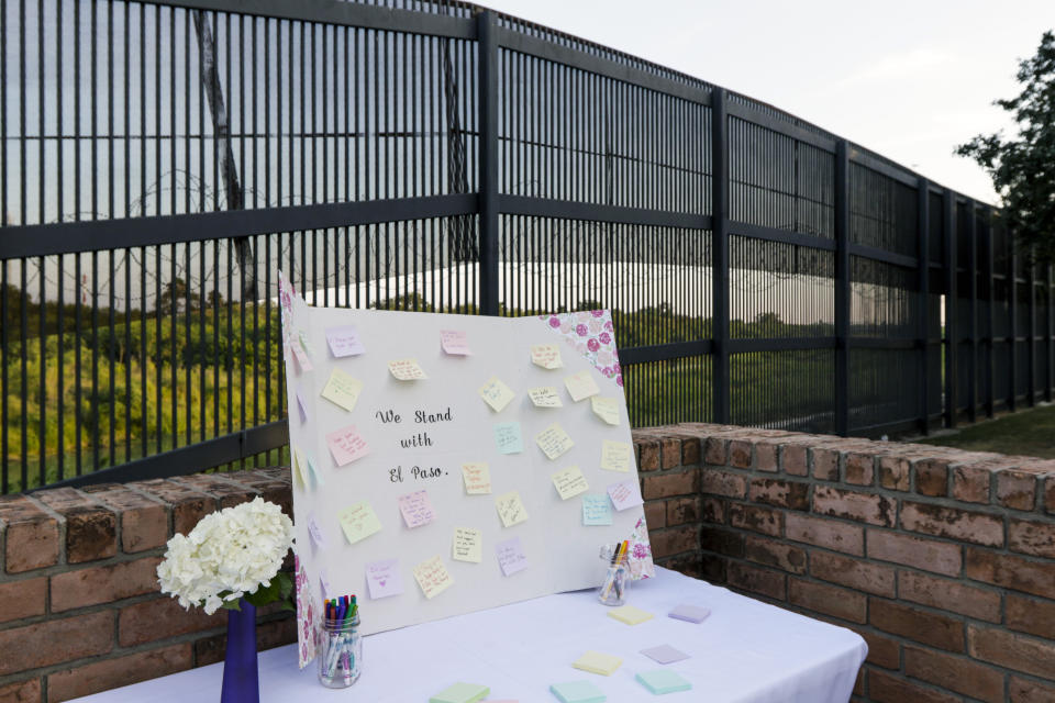 A table with notes and markers allowed community members to share their messages and prayers for the victims of the recent shooting in El Paso during a vigil Sunday, Aug. 11, 2019, at Alice Wilson Hope Park in Brownsville, Texas.(Denise Cathey/The Brownsville Herald via AP)