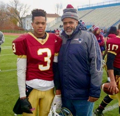 Tariq Masenburg and his father, James, pose after a Doherty football game.