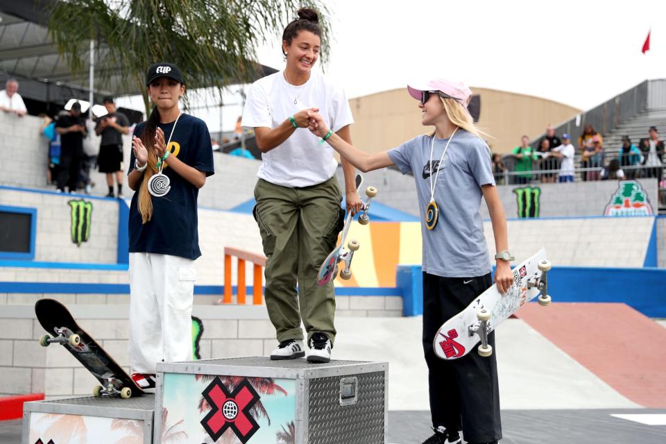 Mariah Duran, center, and Chloe Covell fist pump while on the podium along with Liz Akama of Japan following the Women's Skateboard Street Best Trick during X Games 2023 in Ventura on Sunday, July 23, 2023.