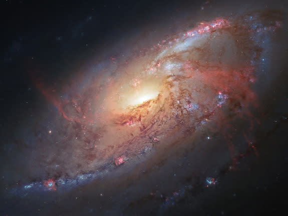 This space wallpaper combines Hubble observations of M 106 with additional information captured by amateur astronomers Robert Gendler and Jay GaBany. Gendler combined Hubble data with his own observations to produce this stunning color image.