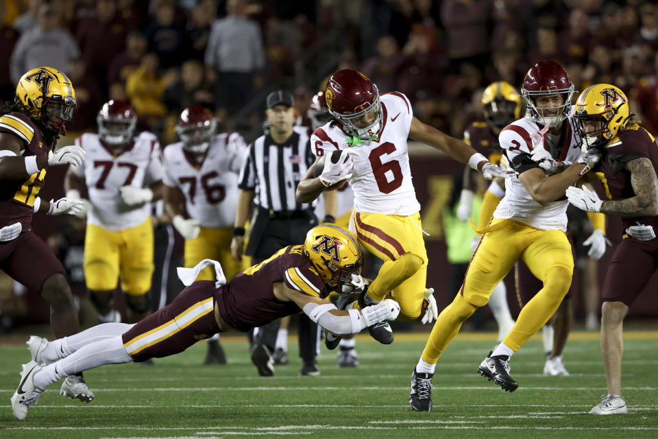 Minnesota defensive back Koi Perich tackles Southern California wide receiver Makai Lemon (6) during the first half of an NCAA college football game, Saturday, Oct. 5, 2024, in Minneapolis. (AP Photo/Ellen Schmidt)