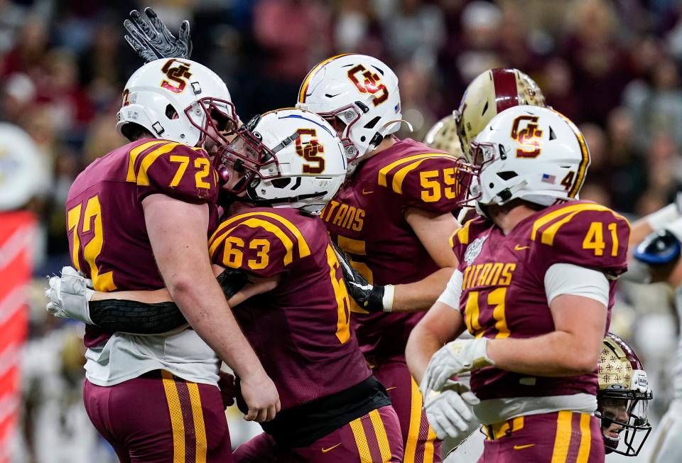 Gibson Southern Titan players celebrate during the IHSAA Class 3A State Finals on Friday, Nov. 26, 2021, at Lucas Oil Stadium in Indianapolis.  Gibson Southern Titans defeated Brebeuf Jesuit for the IHSAA Class 3A State championship, 45-35.