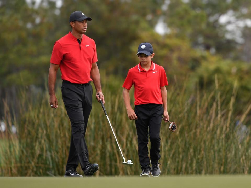 Tiger Woods walks with son Charlie Woods during the final round of the 2020 PNC Championship.