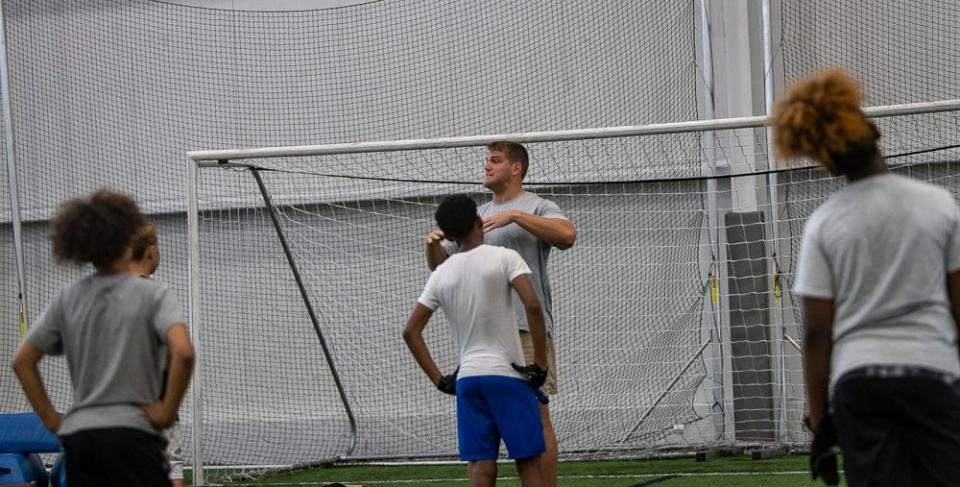 Brian O'Neill of the Minnesota Vikings speaks at a free NFL clinic for youths at Chase Fieldhouse, Friday, June 17, 2022.