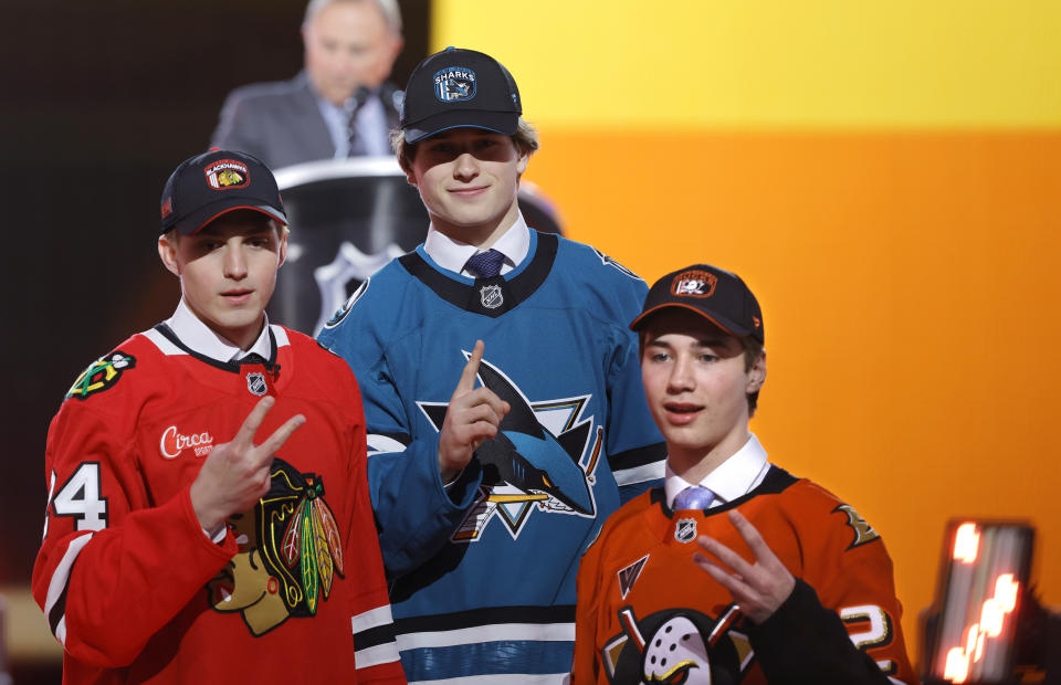 Artyom Levshunov, left, second overall pick of the Chicago Blackhawks; Macklin Celebrini, center, first overall pick of the San Jose Sharks; and Beckett Sennecke, third overall pick of the Anaheim Ducks, pose during the first round of the NHL hockey draft Friday, June 28, 2024, in Las Vegas. (AP Photo/Steve Marcus)