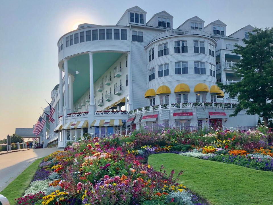The Grand Hotel Mackinac Island, a white building surrounded by flowers