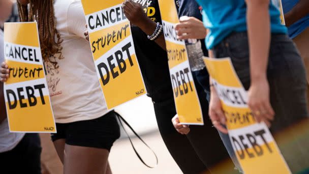 PHOTO: Activists hold cancel student debt signs as they gather to rally in front of the White House, Aug. 25, 2022.  (Stefani Reynolds/AFP via Getty Images)